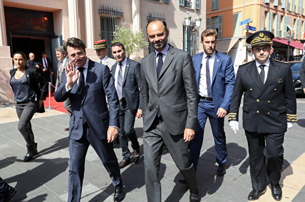 French Prime Minister Edouard Philippe (C) walks with The Mayor of Nice Christian Estrosi (C/L) as he arrives in Nice on July 14, 2018, to attend a ceremony for the second anniversary of attacks on the French coastal city in which 86 people died when a truck was driven into a crowd celebrating Bastille Day on the Promenade des Anglais. France is deploying 110,000 police and security forces nationwide this weekend to secure the huge street parties if the national team win the World Cup on July 15. The country has been repeatedly targeted by extremists over previous years in attacks that have claimed 246 lives since January 2015, according to an AFP toll.