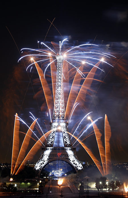 PARIS, FRANCE - JULY 14: Fireworks burst around the Eiffel Tower as part of Bastille Day celebrations on July 14, 2018 in Paris, France. The theme of the fireworks of this year is dedicated to the romanticism.