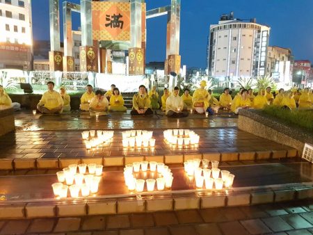 云林法轮功学员14日在斗六圆环冒着风雨举办烛光悼念会。