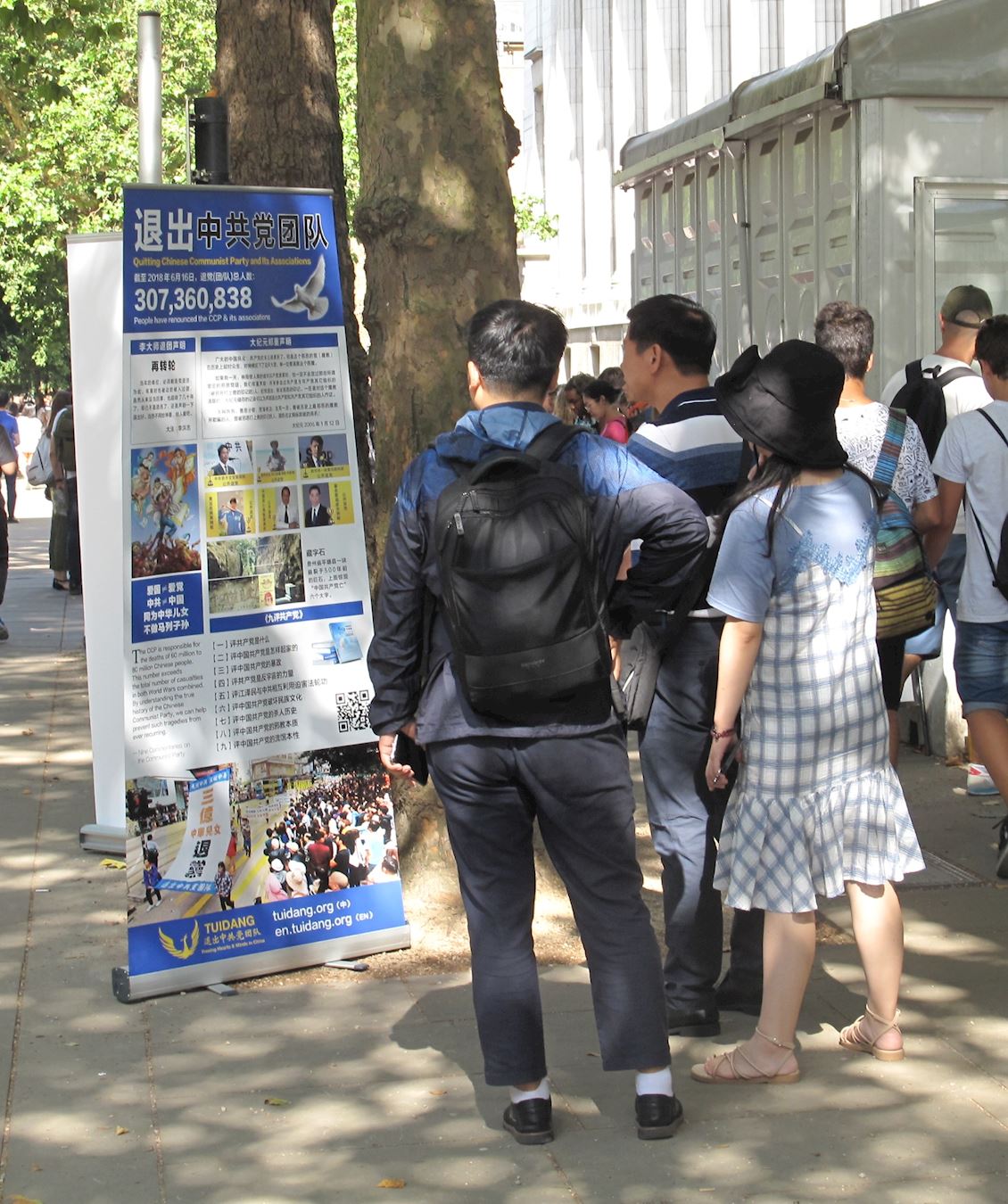 中国游客看真相展板。(明慧网)