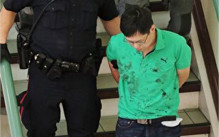 A blood covered man is escorted in handcuffs form a stabbing incident in the Perpetual Wellness Chinese Medicine Centre on Thursday June 16, 2016 Gavin Young/Postmedia