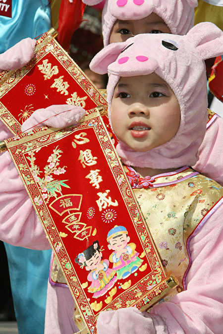 Hong Kong, CHINA: Children dressed in pig costumes take part in a performance at a shopping mall in Hong Kong 30 January 2007. The shopping mall function was held for the upcoming Chinese New Year which falls on 19 February 2007. This year heralds in the Year of the Pig. AFP PHOTO/MIKE CLARKE (Photo credit should read MIKE CLARKE/AFP/Getty Images)