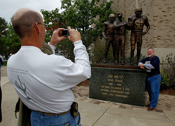 SOUTH BEND, IN - SEPTEMBER 25: Fans take pictures in front of a statue of former head coach Lou Holtz of the Notre Dame Fighting Irish before a game against the Stanford Cardinal at Notre Dame Stadium on September 25, 2010 in South Bend, Indiana. (Photo by Jonathan Daniel/Getty Images)