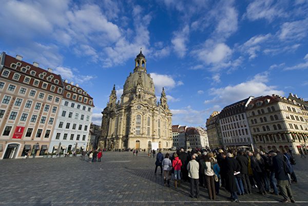 Tourists look at the Frauenkirche ( Church of Our Lady ) in Dresden, eastern Germany, on November 16, 2015. The church is an identical version of the original Frauenkirche, built with what was salvaged from the remains of the former church after allied bombing at the end of WWII. AFP PHOTO / ROBERT MICHAEL (Photo credit should read ROBERT MICHAEL/AFP/Getty Images)