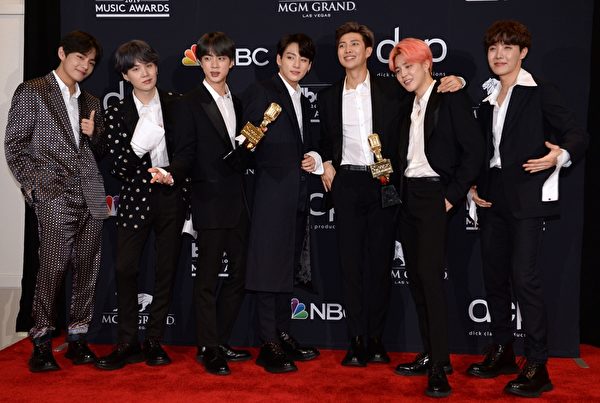 BTS poses in the press room with their awards during the 2019 Billboard Music Awards