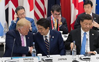 JAPAN-G20-SUMMIT US President Donald Trump (L) shakes hands with Japan's Prime Minister Shinzo Abe (C) as they sit beside China's President Xi Jinping as they attend a meeting on the digital economy at the G20 Summit in Osaka on June 28, 2019. (Photo by Jacques Witt / POOL / AFP) (Photo credit should read JACQUES WITT/AFP/Getty Images)