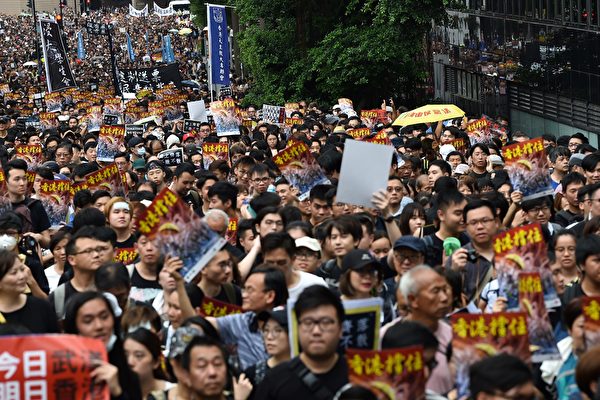 Protesters take part in a march to the West Kowloon railway station during a demonstration against a proposed extradition bill in Hong Kong on July 7, 2019. - Thousands of anti-government protesters began a march in Hong Kong on July 7 that will end outside a controversial train station linking the territory to the Chinese mainland, as activists try to keep pressure on the city's pro-Beijing leaders. (Photo by Hector RETAMAL / AFP) (Photo credit should read