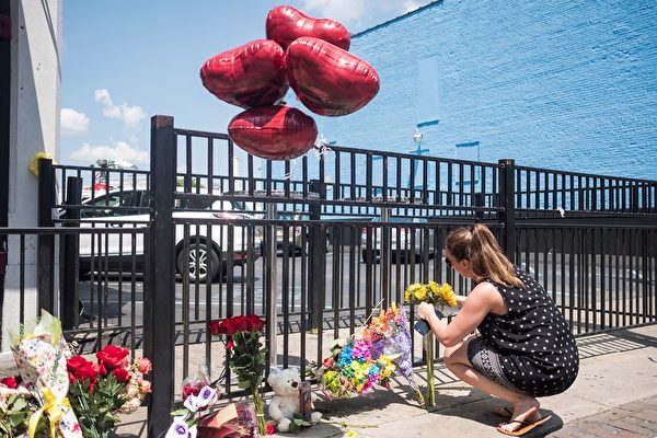 People come to pay their respect to those who lost their lives after the mass shooting over the weekend in Dayton, Ohio on August 5, 2019. - US President Donald Trump urged Republicans and Democrats to agree on tighter gun control and suggested legislation could be linked to immigration reform after two shootings left 30 people dead and sparked accusations that his rhetoric was part of the problem. "Republicans and Democrats must come together and get strong background checks, perhaps marrying this legislation with desperately needed immigration reform," Trump tweeted as he prepared to address the nation on two weekend shootings in Texas and Ohio. "We must have something good, if not GREAT, come out of these two tragic events!" Trump wrote. (Photo by Megan JELINGER / AFP)        (Photo credit should read MEGAN JELINGER/AFP/Getty Images)