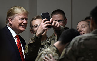 TOPSHOT - US President Donald Trump poses for selfies during a Thanksgiving dinner with US troops at Bagram Air Field during a surprise visit on November 28, 2019 in Afghanistan. (Photo by Olivier Douliery / AFP) (Photo by OLIVIER DOULIERY/AFP via Getty Images)