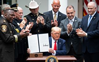 US President Donald Trump shows his signature on an Executive Order on Safe Policing for Safe Communities, in the Rose Garden of the White House in Washington, DC, June 16, 2020. (Photo by SAUL LOEB / AFP) (Photo by SAUL LOEB/AFP via Getty Images)