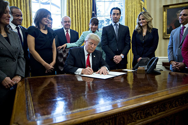 圖為2017年1月30日，特朗普與一群小企業主在白宮會面，簽發行政令，大幅減少對企業的監管。（Photo by Andrew Harrer – Pool/Getty Images）