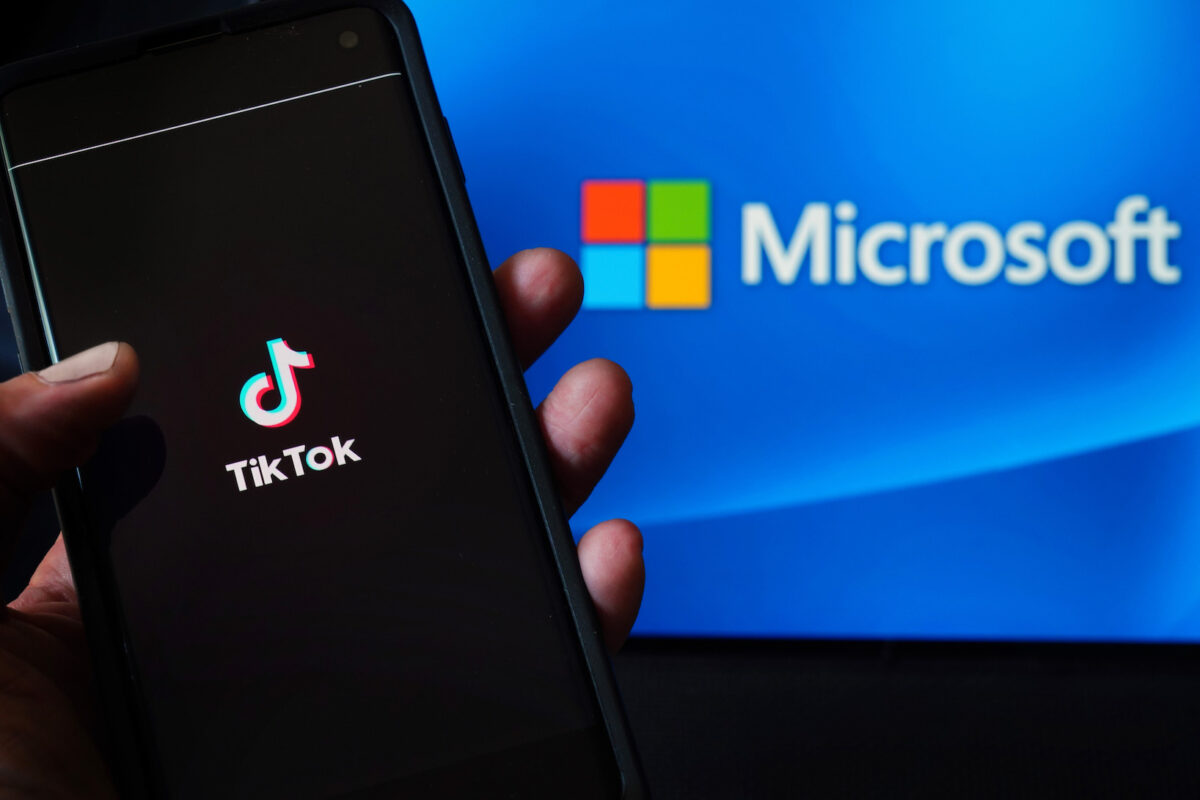 帶有TikTok應用程式的手機顯示在微軟（Microsoft）徽標旁。（2020年8月3日攝於紐約）（Cindy Ord/Getty Images）