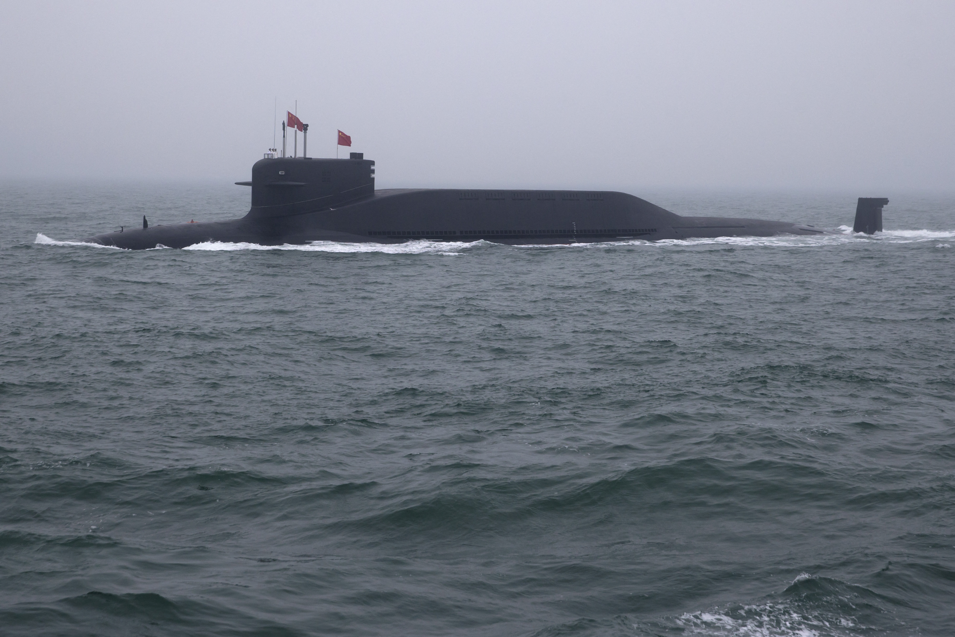 2021年4月23日，中共海军南海舰队一次性接收三型主战舰艇入列，消息称，其中的战略导弹核潜艇上装备了中共迄今射程最远的潜射弹道导弹。图为中共094型战略核潜舰。(Mark Schiefelbein/AFP)