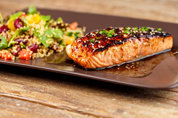 Grilled Salmon With Quinoa Salad On Brown Plate