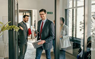 Shot Of A Group Of A Businessman Holding The Door
