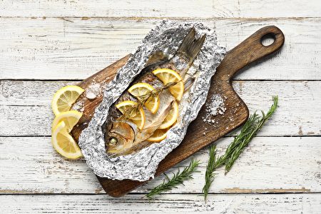 Aluminium Foil With Tasty Baked Fish Lemon Slices And Rosemary