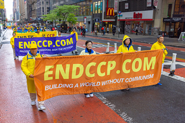 Falun Gong practitioners take part in a parade to celebrate Worl
