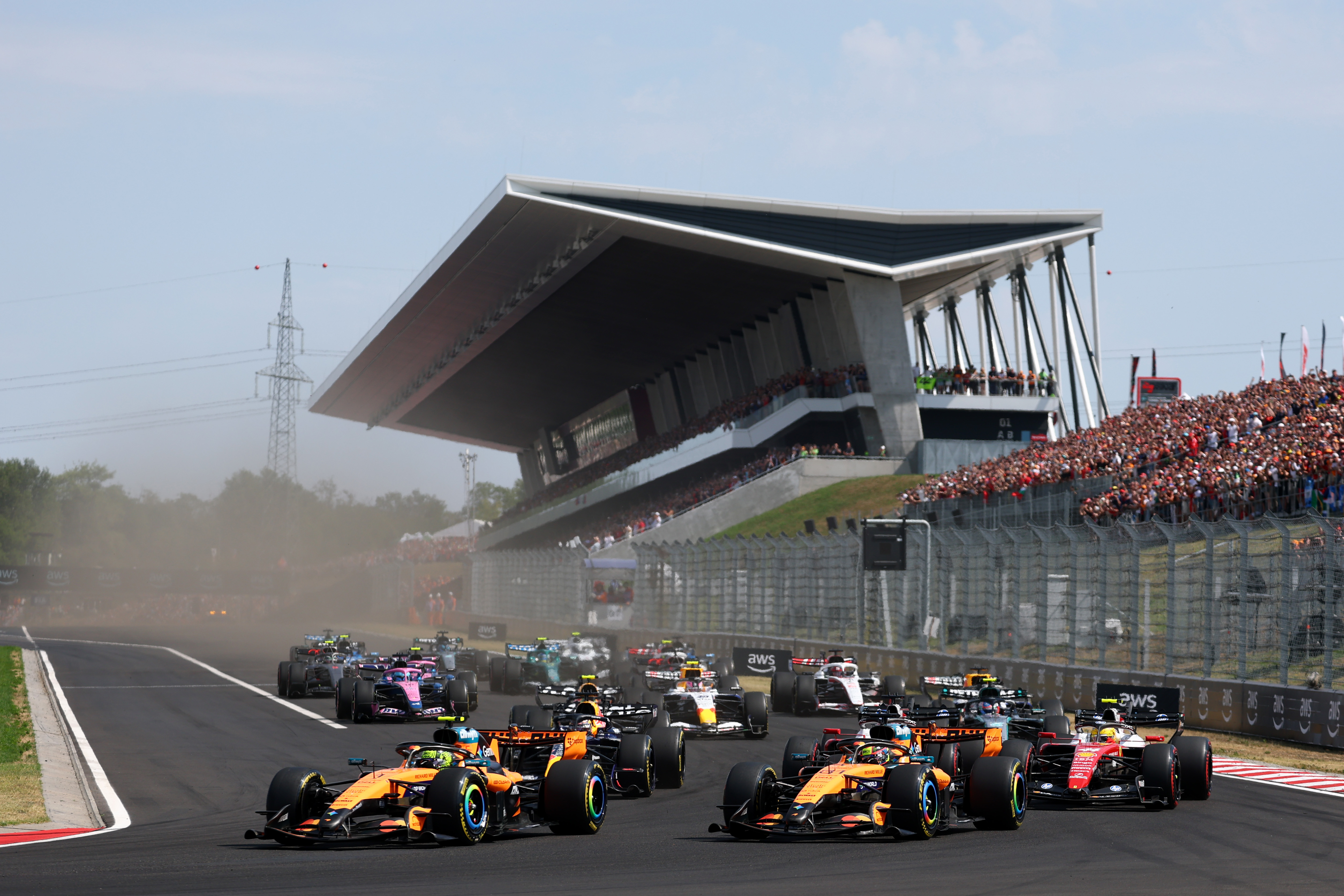 2026年7月26日,F1大奖赛匈牙利站,迈凯伦车队的英国车手诺里斯(Lando Norris)杆位发车率先冲线,夺得个人本赛季首场胜利,连续两年在匈牙利登上最高领奖台。图为比赛开始后,赛车进入第一个弯道瞬间。(Clive Rose/Getty Images)