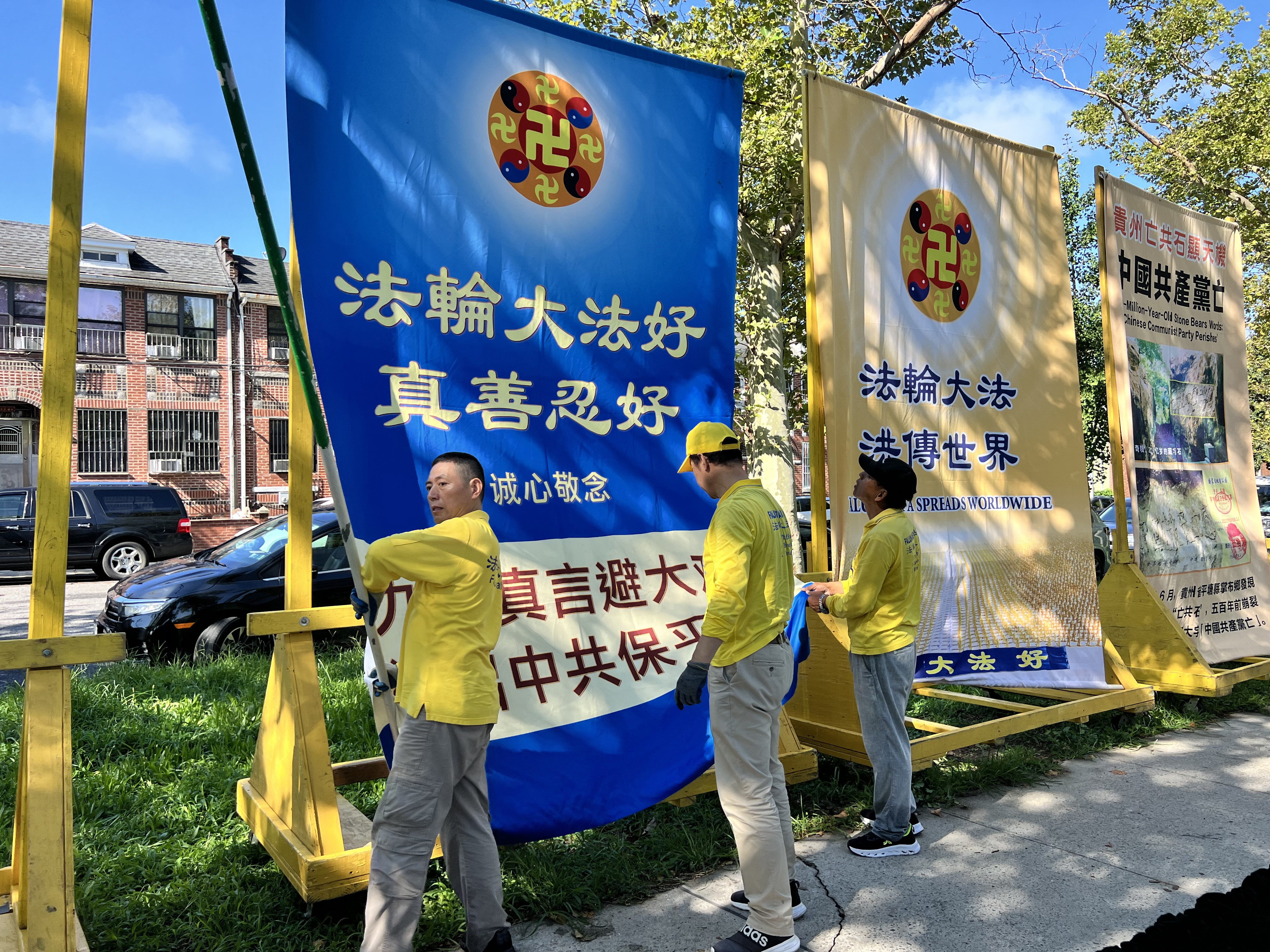 義工現場組裝大型展板。這類配有推車的展板至少有10個,均需在遊行前逐一組裝。(蔡溶/大紀元)